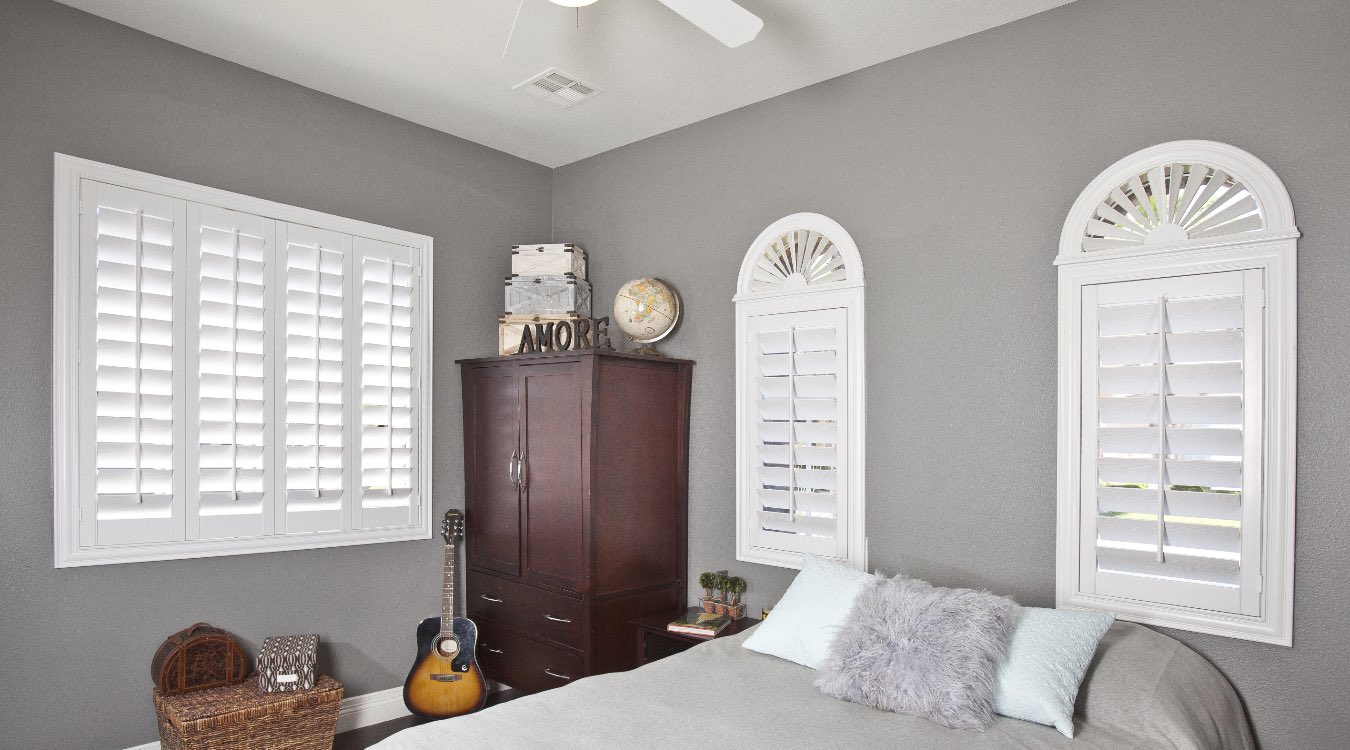 Arched plantation shutters in bedroom