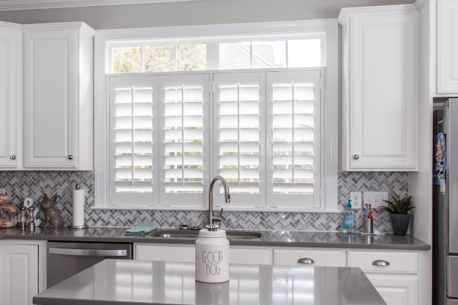 White Polywood shutters above a kitchen sink