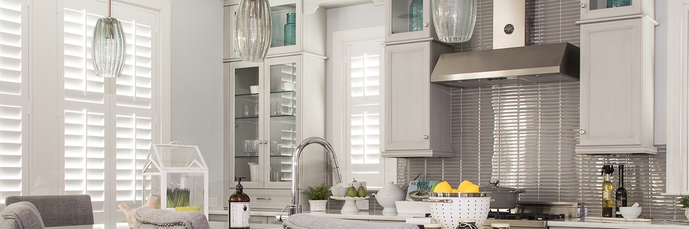 White polywood shutters over a kitchen sink